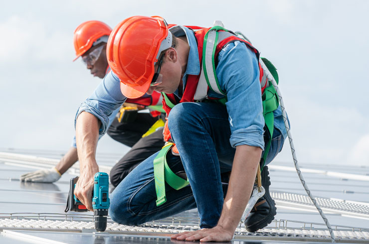 Commercial Roofing Service man working on roof